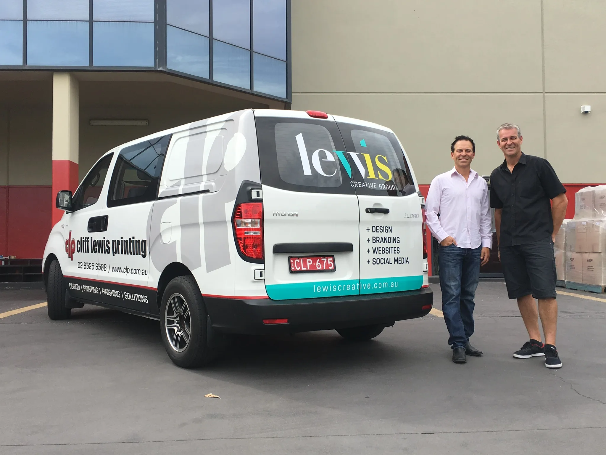 Lewis Media Group van with branded vehicle signage outside warehouse in Sydney
